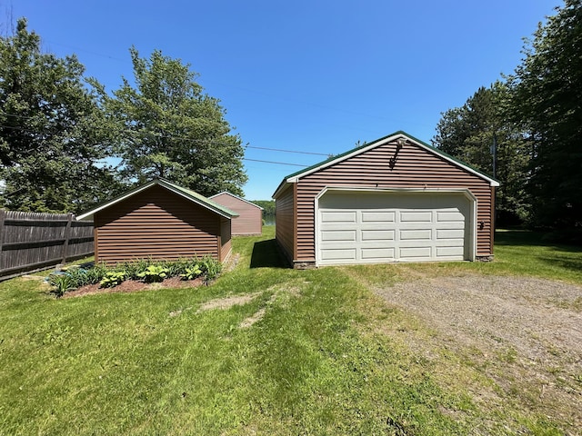 detached garage featuring fence