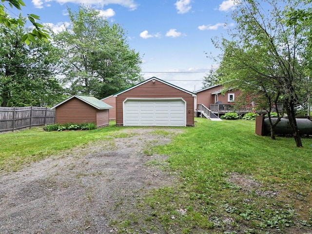 detached garage featuring fence