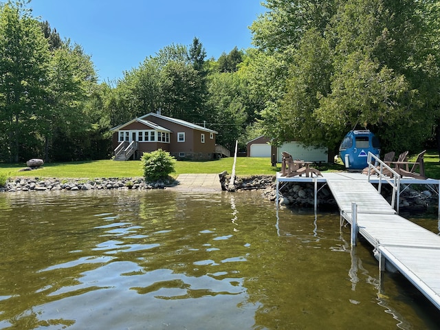 view of dock featuring a water view and a lawn