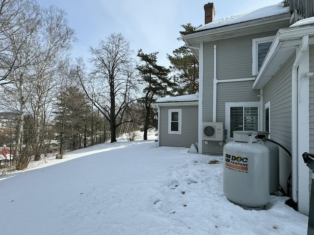yard layered in snow featuring ac unit