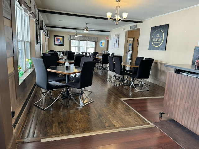 dining area with visible vents, wood finished floors, an inviting chandelier, and ornamental molding