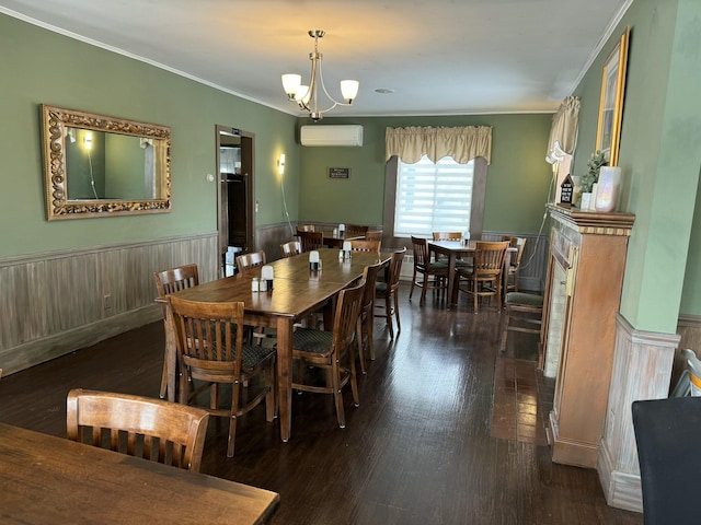dining area featuring an AC wall unit, crown molding, dark wood-style floors, and wainscoting