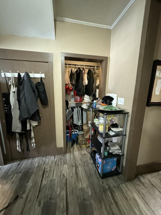interior space with wood finished floors, baseboards, and ornamental molding