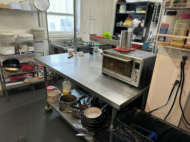 kitchen with stainless steel countertops, stainless steel microwave, and a toaster