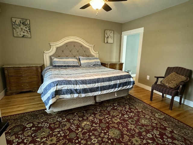 bedroom with baseboards, a ceiling fan, and wood finished floors