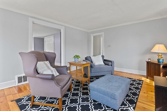 59 Brigham St, South Portland, ME 04106 - living area featuring visible vents, hardwood / wood-style floors, crown molding, and baseboards