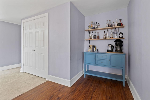 59 Brigham St, South Portland, ME 04106 - bar featuring dark wood-type flooring, a bar, and baseboards