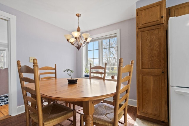 59 Brigham St, South Portland, ME 04106 - dining room with a notable chandelier, wood finished floors, and baseboards