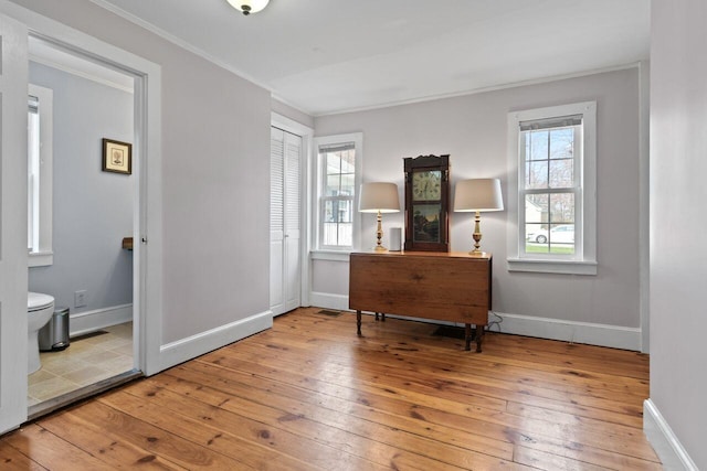 59 Brigham St, South Portland, ME 04106 - bedroom with ensuite bath, a closet, ornamental molding, wood-type flooring, and baseboards