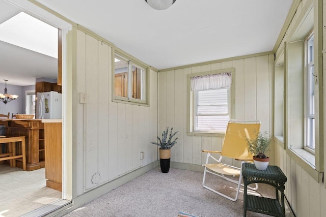 59 Brigham St, South Portland, ME 04106 - sitting room featuring wood walls, an inviting chandelier, a wealth of natural light, and carpet