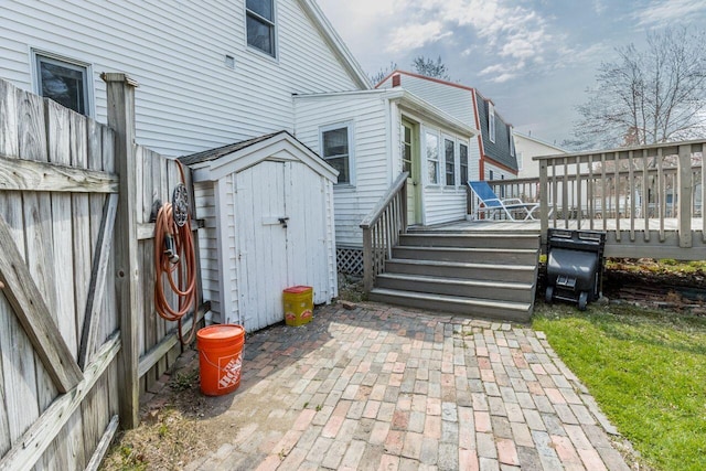 59 Brigham St, South Portland, ME 04106 - view of property exterior with an outdoor structure, a wooden deck, and a storage shed