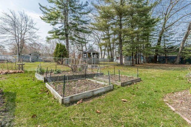 59 Brigham St, South Portland, ME 04106 - view of yard featuring a vegetable garden and fence