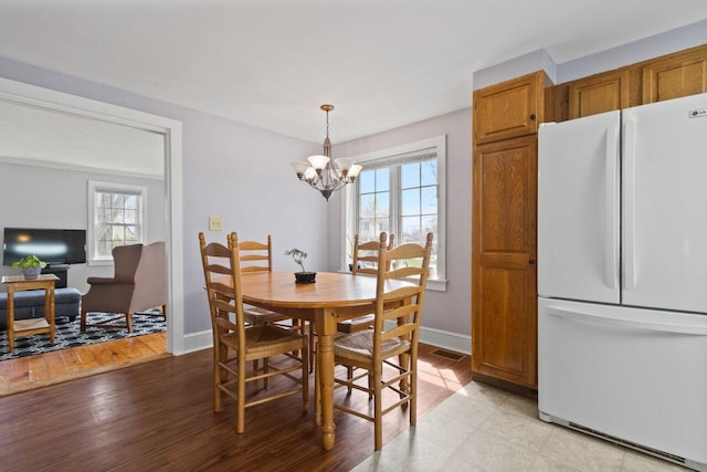59 Brigham St, South Portland, ME 04106 - dining room featuring visible vents, a notable chandelier, baseboards, and a healthy amount of sunlight