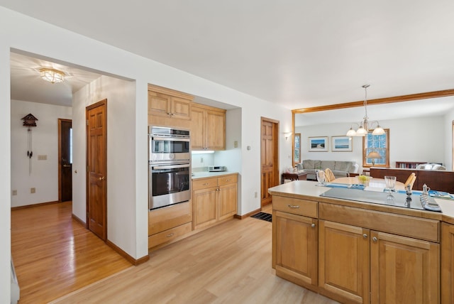 19 Windsor Pines Dr, Scarborough, ME 04074 - kitchen featuring a chandelier, stainless steel double oven, light wood-type flooring, light countertops, and pendant lighting