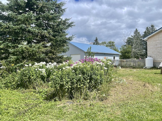 view of yard featuring fence and an attached garage