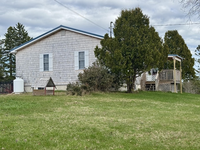 back of house featuring a wooden deck and a yard