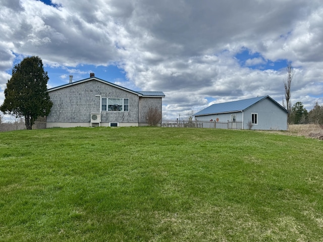 rear view of property with a lawn and fence