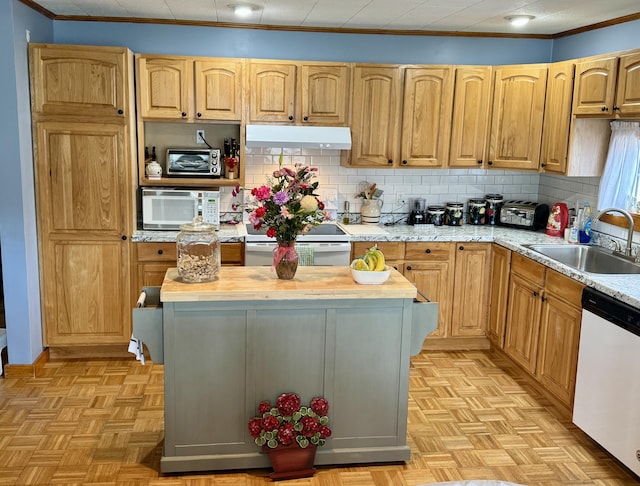 kitchen with under cabinet range hood, backsplash, white appliances, a sink, and wood counters