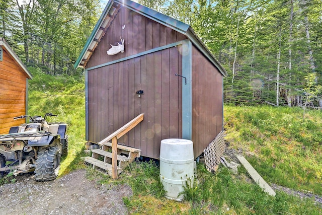 view of shed with a forest view