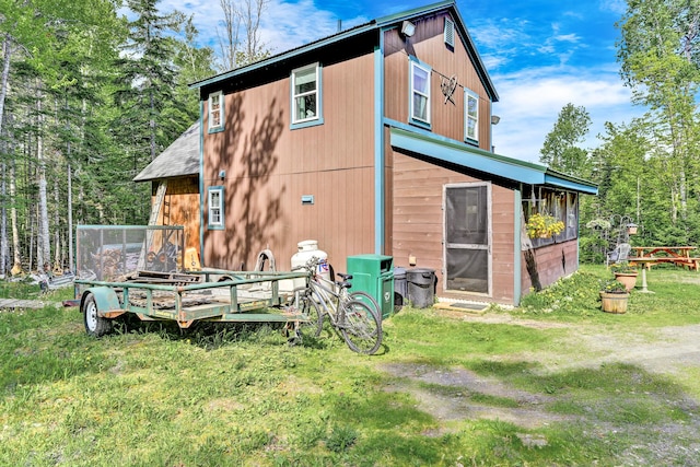 back of property featuring a yard