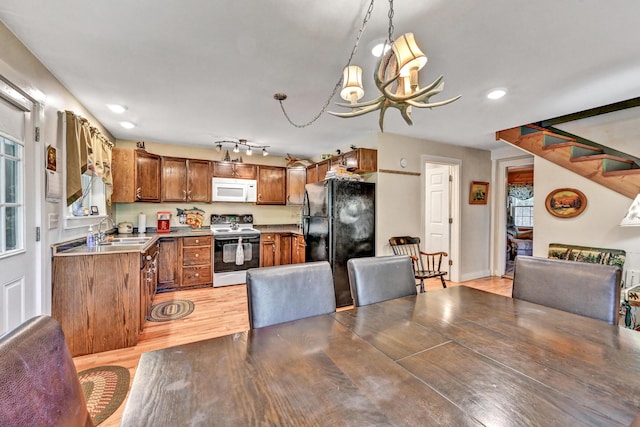 dining room with stairs, recessed lighting, a chandelier, and light wood-style floors