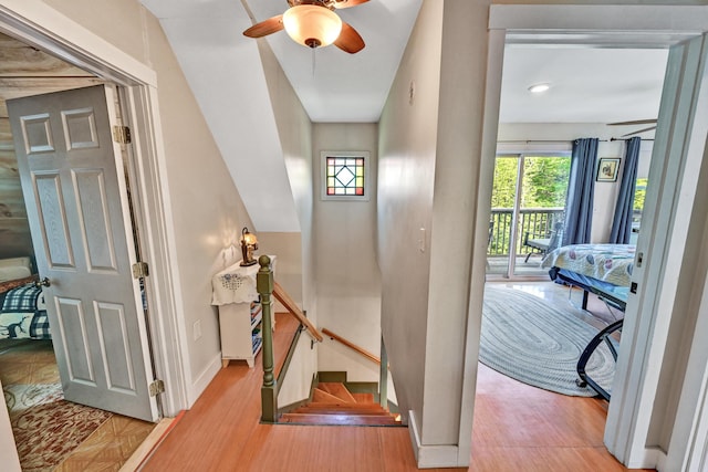 interior space with baseboards, ceiling fan, and wood finished floors
