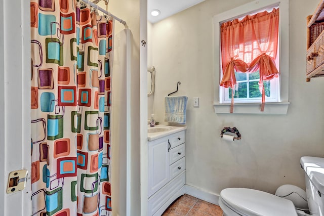 bathroom featuring a shower with curtain, vanity, tile patterned floors, baseboards, and toilet