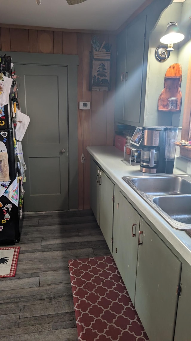 kitchen featuring light countertops, a sink, and dark wood-type flooring