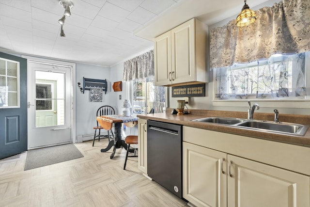 kitchen with dishwashing machine, a sink, a baseboard radiator, and cream cabinets