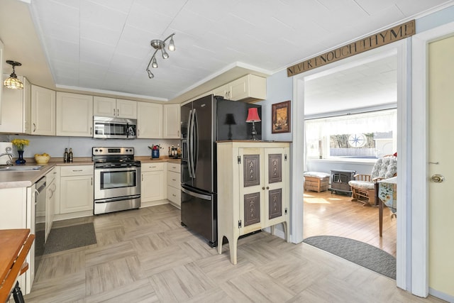 kitchen featuring light countertops, appliances with stainless steel finishes, and a sink