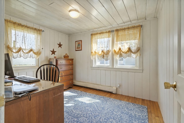 office with a baseboard heating unit, light wood-style floors, and plenty of natural light