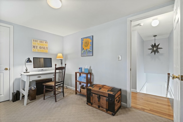 carpeted office featuring baseboards