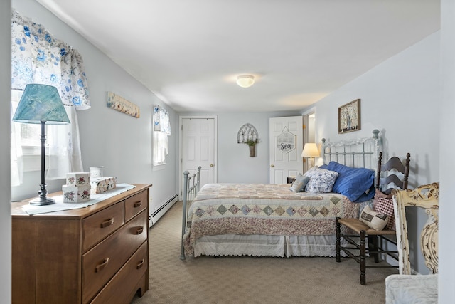 carpeted bedroom featuring a baseboard heating unit