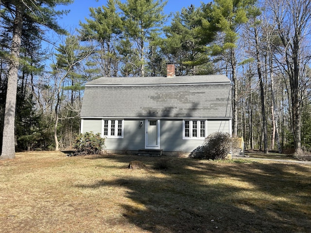 7 Kathryn St, Gorham, ME 04038 - rear view of property with a lawn, a chimney, entry steps, and a gambrel roof