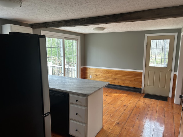7 Kathryn St, Gorham, ME 04038 - kitchen featuring white cabinets, dishwasher, light countertops, light wood-style flooring, and freestanding refrigerator
