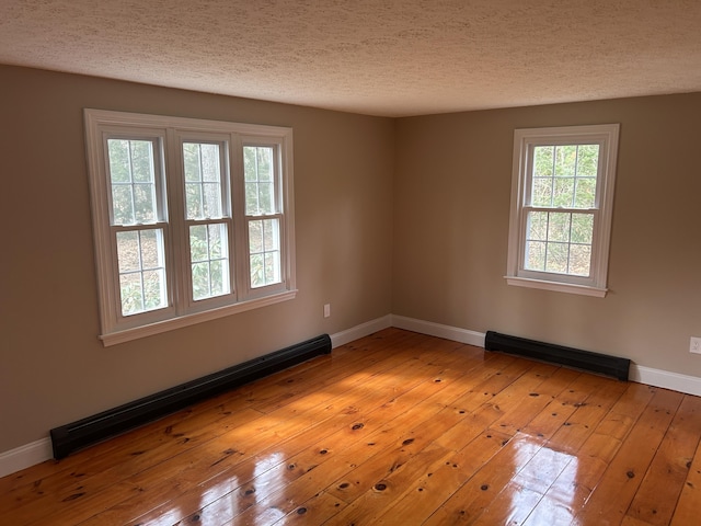 7 Kathryn St, Gorham, ME 04038 - spare room with a textured ceiling, baseboards, light wood-style flooring, and a baseboard radiator