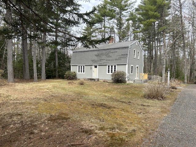 7 Kathryn St, Gorham, ME 04038 - view of front facade with a gambrel roof, roof with shingles, and a chimney
