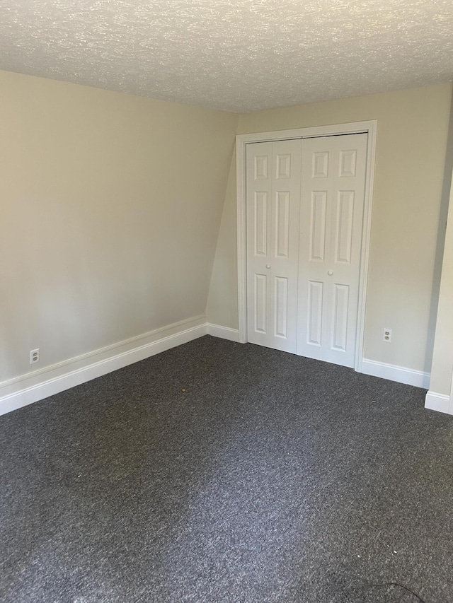 7 Kathryn St, Gorham, ME 04038 - unfurnished bedroom with a closet, a textured ceiling, and carpet