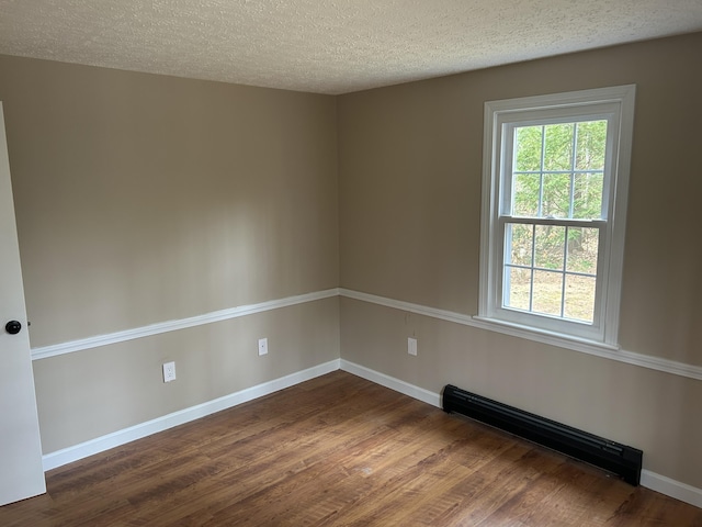 7 Kathryn St, Gorham, ME 04038 - spare room with dark wood-style flooring, baseboards, baseboard heating, and a textured ceiling