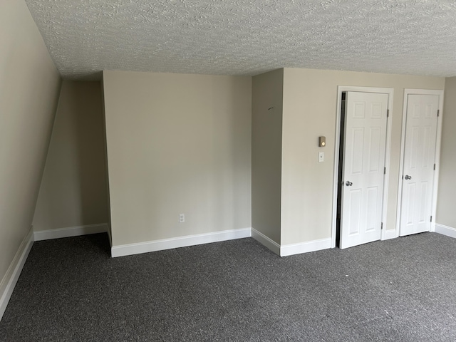 7 Kathryn St, Gorham, ME 04038 - spare room with baseboards, dark carpet, and a textured ceiling