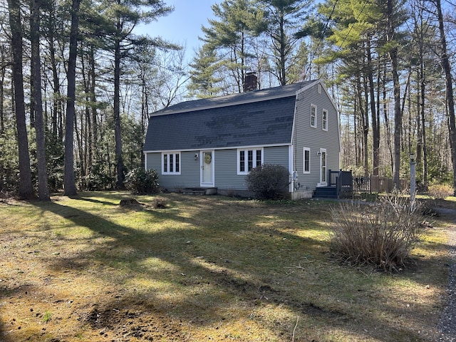 7 Kathryn St, Gorham, ME 04038 - view of front of house featuring a shingled roof, a chimney, a gambrel roof, and a front yard