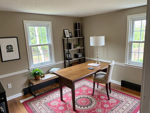 7 Kathryn St, Gorham, ME 04038 - office area featuring visible vents, baseboards, wood finished floors, and a healthy amount of sunlight