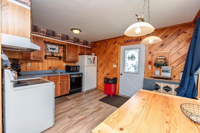 90 Manor Dr, Rangeley, ME 04970 - kitchen with wood walls, a sink, light wood-type flooring, black appliances, and hanging light fixtures