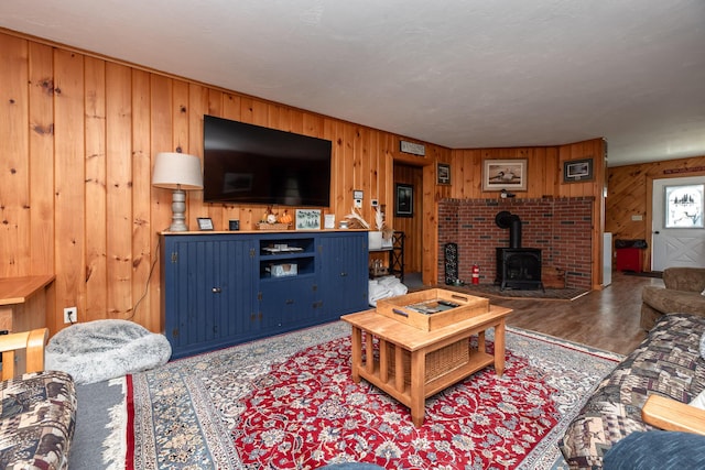 90 Manor Dr, Rangeley, ME 04970 - living area featuring wooden walls, wood finished floors, and a wood stove