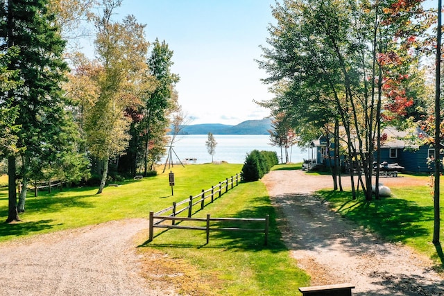 90 Manor Dr, Rangeley, ME 04970 - view of community with driveway, a water and mountain view, and a yard