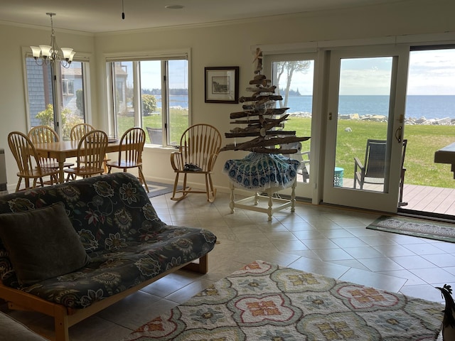 sunroom / solarium featuring plenty of natural light, a water view, and an inviting chandelier