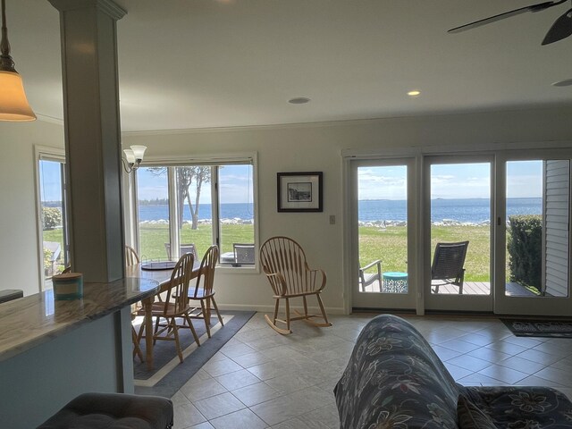 dining area featuring a water view, baseboards, recessed lighting, a ceiling fan, and light tile patterned floors