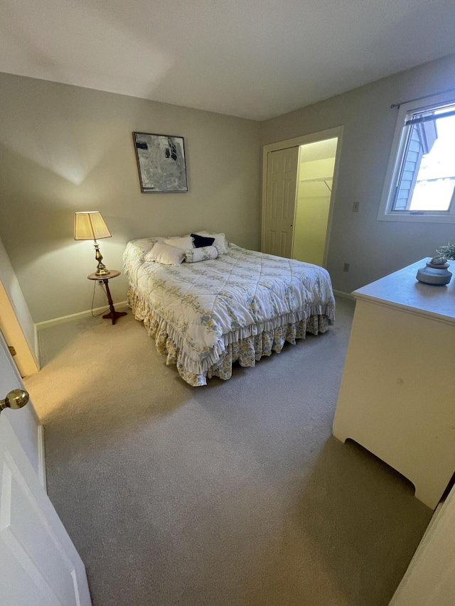 bedroom with baseboards and carpet