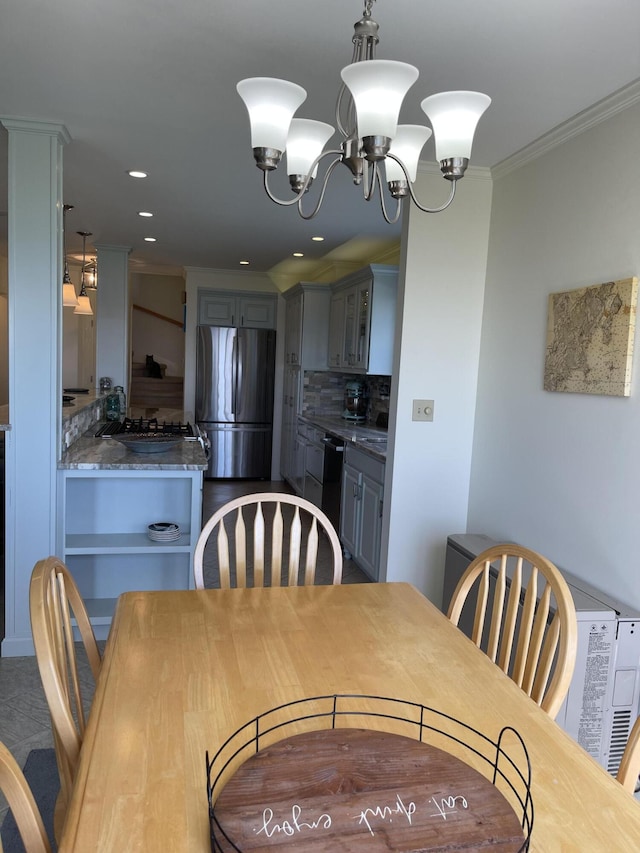 dining room featuring an inviting chandelier, recessed lighting, and crown molding