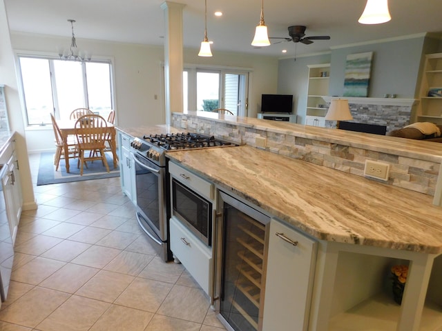 120 Bellevue St Unit 4, Owls Head, ME 04854 - kitchen with beverage cooler, stainless steel range with gas cooktop, light tile patterned floors, built in microwave, and open floor plan